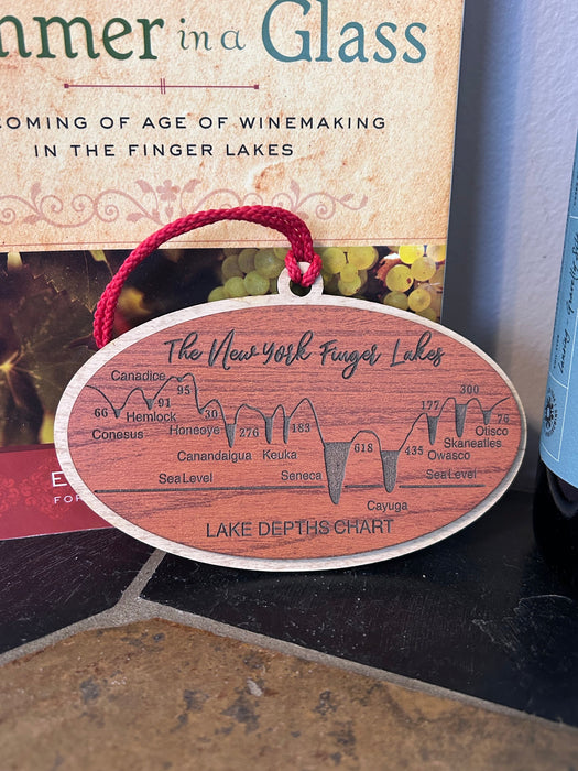 Finger Lakes depth chart wood ornament flat lay showing cherry and maple layers