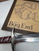 Sword with ornate hilt on a map of 'Bag End' from 'The Lord of the Rings'.