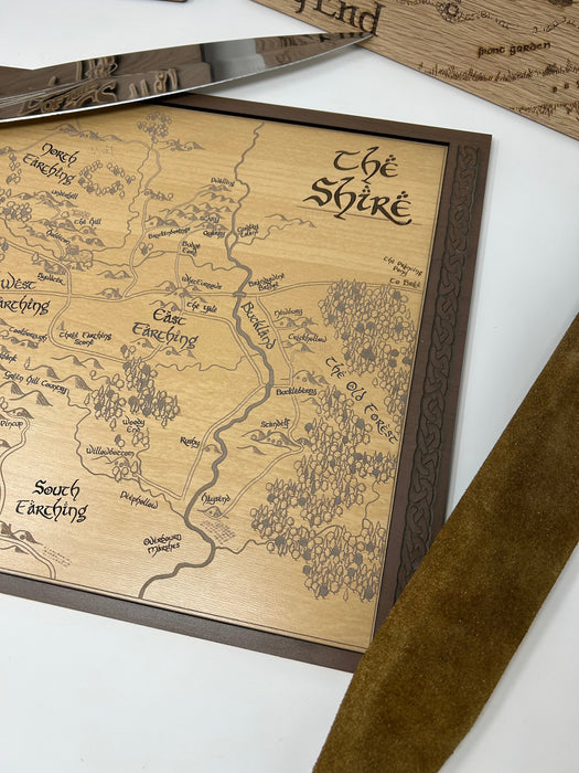 Wooden map of 'The Shire' with a brown frame on a white surface.