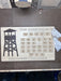 Wooden plaque with 'The Adirondack Firetower Challenge' design on workbench