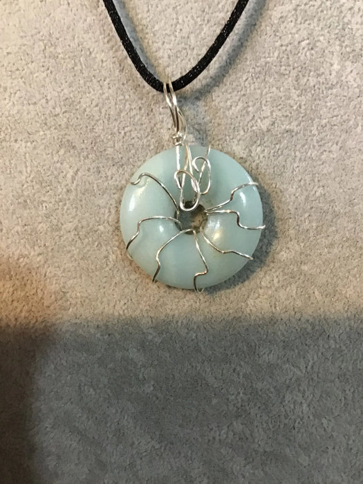 Wire wrapped gemstone donut on 18" black satin adjustable cord.