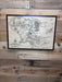 Map of Middle-earth with a Walnut Frame hanging on a wall