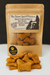 A bag of Bacon Cheddar Biscuits with Duvall Farms Bacon. Handmade organic dog treats from The Chosen Spot K9 Kitchen with a pile of treats in front.
