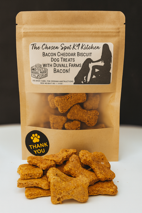 A bag of Bacon Cheddar Biscuits with Duvall Farms Bacon. Handmade organic dog treats from The Chosen Spot K9 Kitchen with a pile of treats in front.