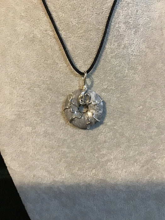 Wire wrapped gemstone donut on 18" black satin adjustable cord.