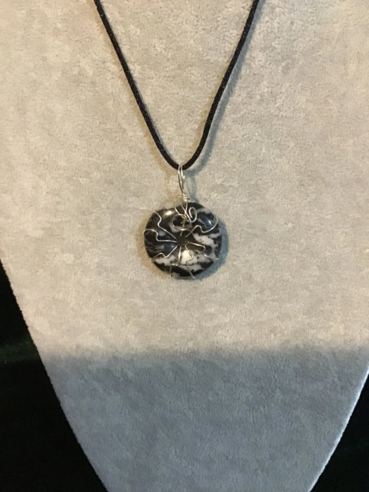 Wire wrapped gemstone donut on 18" black satin adjustable cord.