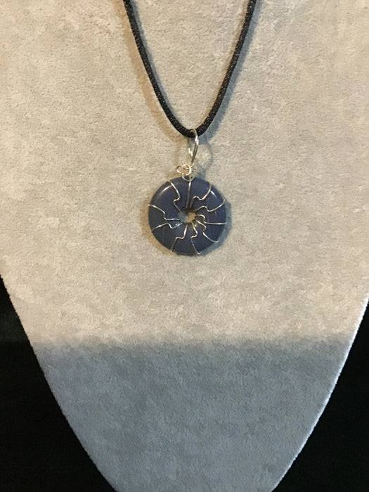 Wire wrapped gemstone donut on 18" black satin adjustable cord.