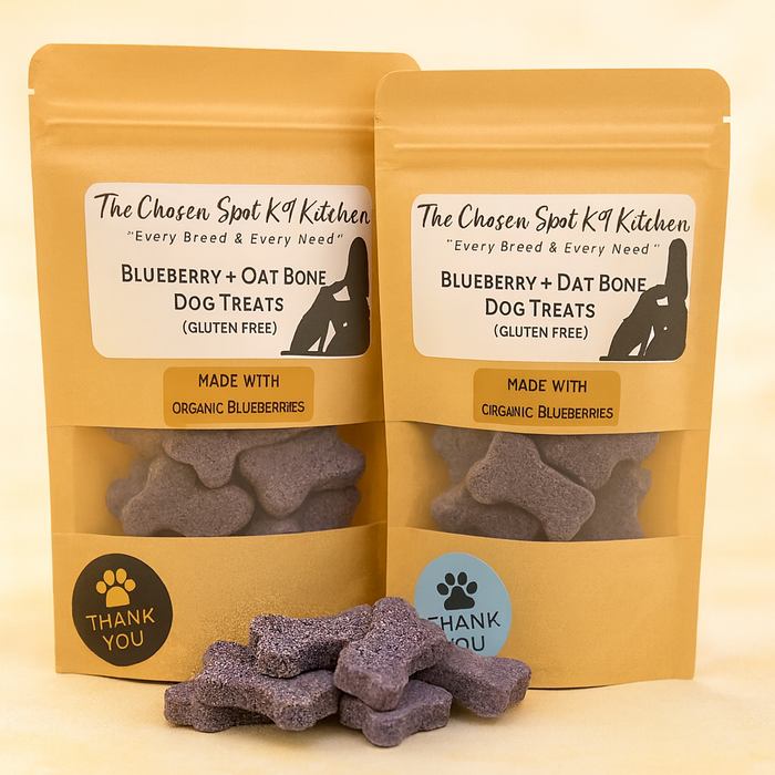 6oz and 3oz bags of Blueberry + Oat Bone Dog Handmade Organic Dog Treats from The Chosen Spot K9 Kitchen on a beige background.