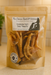 All-natural Chicken Feet organic dog treat from The Chosen Spot K9 Kitchen in a bag on a light colored counter.