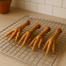 Alll-natural chicken feet handmade organic dog treats from Tje Chosen Spot K9 Kitchen on a metal cooling rack.