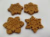 Four Peanut Butter Snowflakes, handmade organic dog treats from The Chose Spot K9 Kitchen on a white background