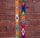 2 different God's Eye colorways in front of a brick background