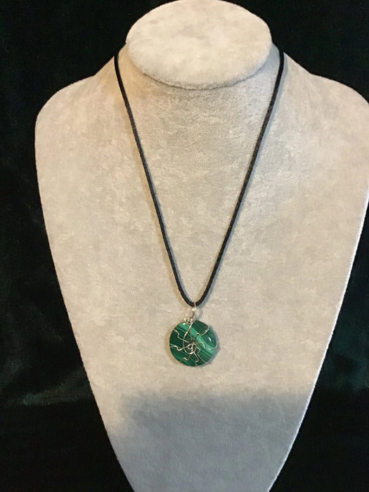 Wire wrapped gemstone donut on 18" black satin adjustable cord.