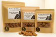 Three packages of 'The Chosen Spot Pet Kitchen' peanut butter bone dog treats on a white background.