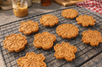 Peanut Butter Flowers, handmade organic dog treats from The Chosen Spot K9 Kitchen on a cooling rack.