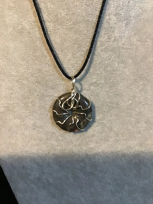 Wire wrapped gemstone donut on 18" black satin adjustable cord.