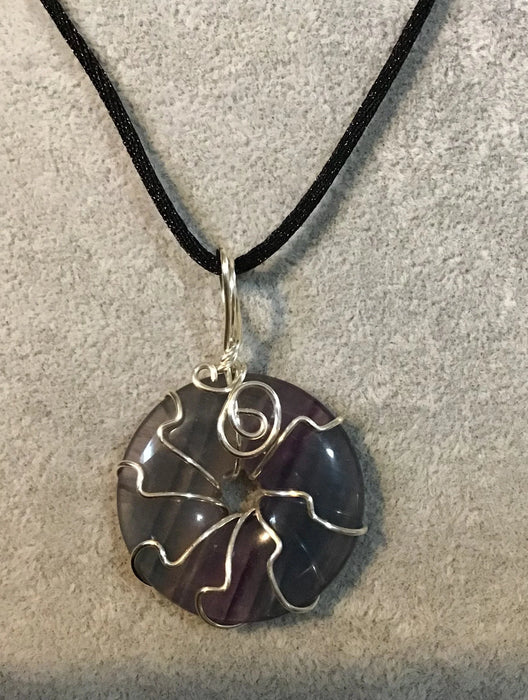 Wire wrapped gemstone donut on 18" black satin adjustable cord.