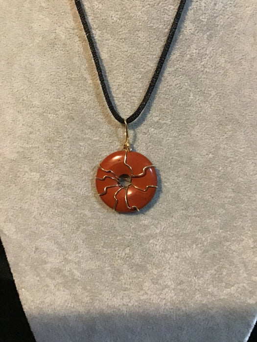 Wire wrapped gemstone donut on 18" black satin adjustable cord.