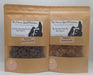 Two packages of handmade organic dog treats, one labeled 'Liver + Blueberry Paws' and the other 'Salmon Paws', from The Chosen Spot K9 Kitchen.