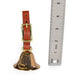 brass sportsmans bird dog bell with tan bridle leather strap. next to ruler showing 4-1/2" tall.