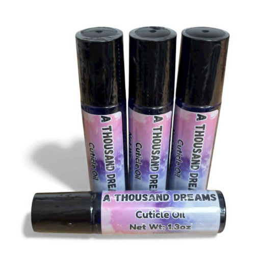 Four bottles of 'A Thousand Dreams' cuticle oil with black caps on a white background.