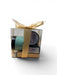 Gift set with a candle and packaging in a clear box with a gold ribbon on a white background