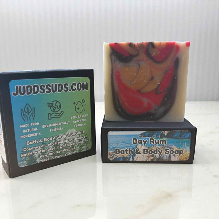 Bar of Bay Rum bath and body soap with packaging on a white surface