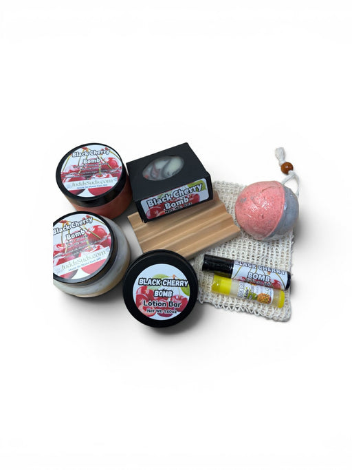 Collection of Black Cherry Bomb products including jars, a bar, and a bath bomb on a white background.