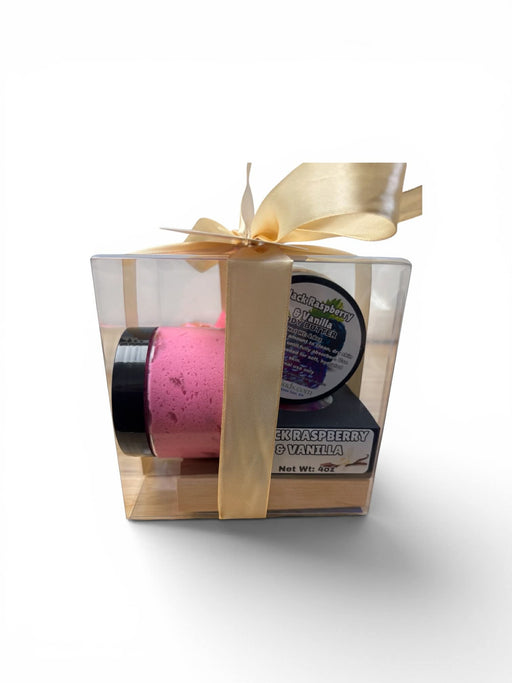 Gift set with black container, and white box wrapped with a gold ribbon on a white background.