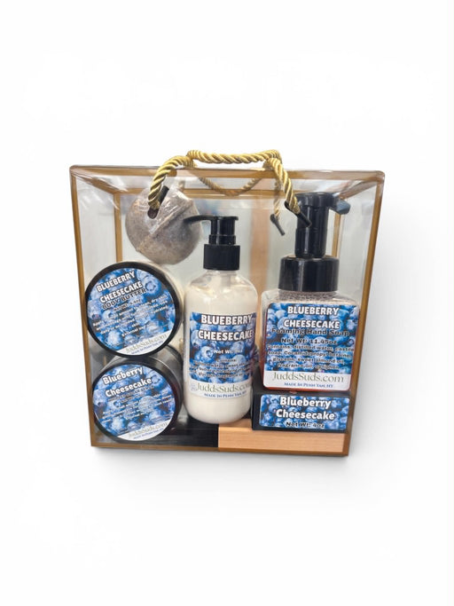 Gift set with Blueberry Cheesecake theme including bottles and containers in a clear bag with wooden handle.