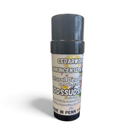 Natural deodorant stick with a gray cap and white label on a white background