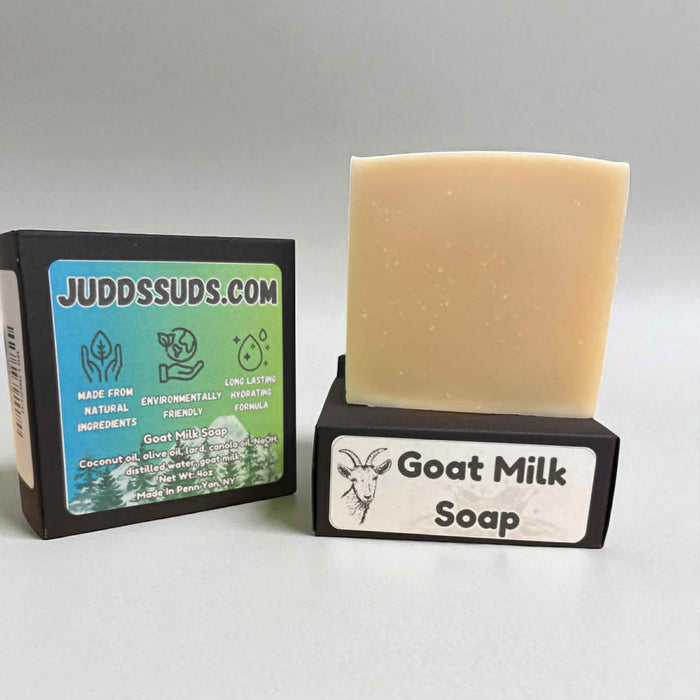 Bar of goat milk soap with packaging displaying 'Judds Suds' branding on a gray background.