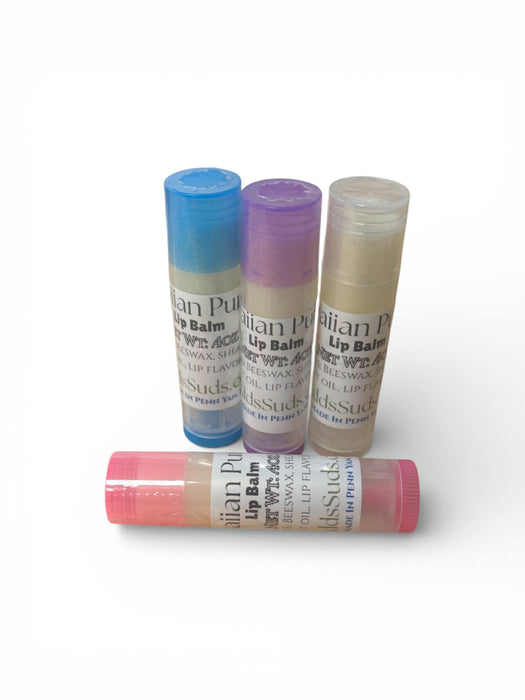 Four lip balms with colorful caps on a white background