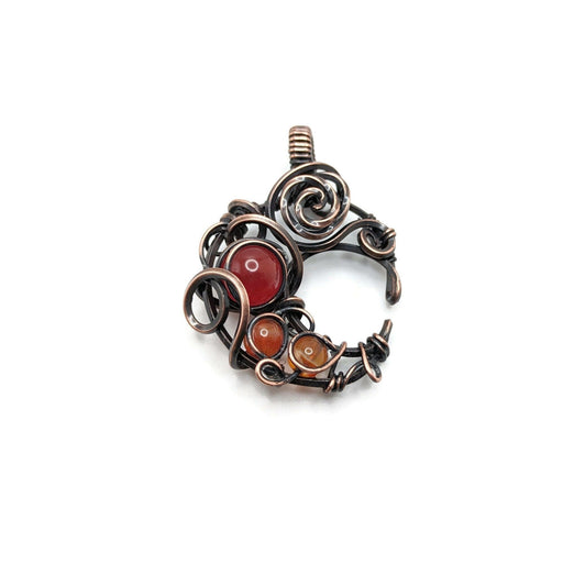 Dark copper moon with carnelian beads, shades of orange and red to accent.