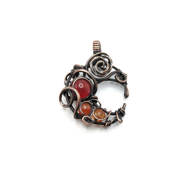 Dark copper moon with carnelian beads, shades of orange and red to accent.