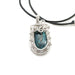 Small turquoise set in a beautiful silver framed pendant, stone is open in the back and is able to touch skin on both sides. Hangs on a black handmade leather cord necklace.