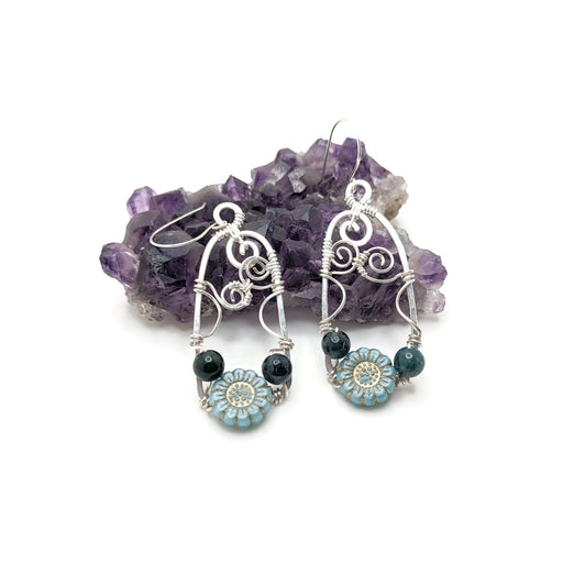 Silver doorway earrings with light blue wildflower and blue beads.
