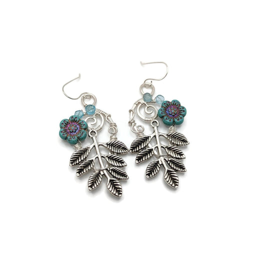 Silver earrings with leaves, blue flowers, and small blue apatite beads.