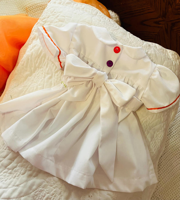 Smocked fish on a summer day. Baby girl dress-White with multicolored smocking, lined.