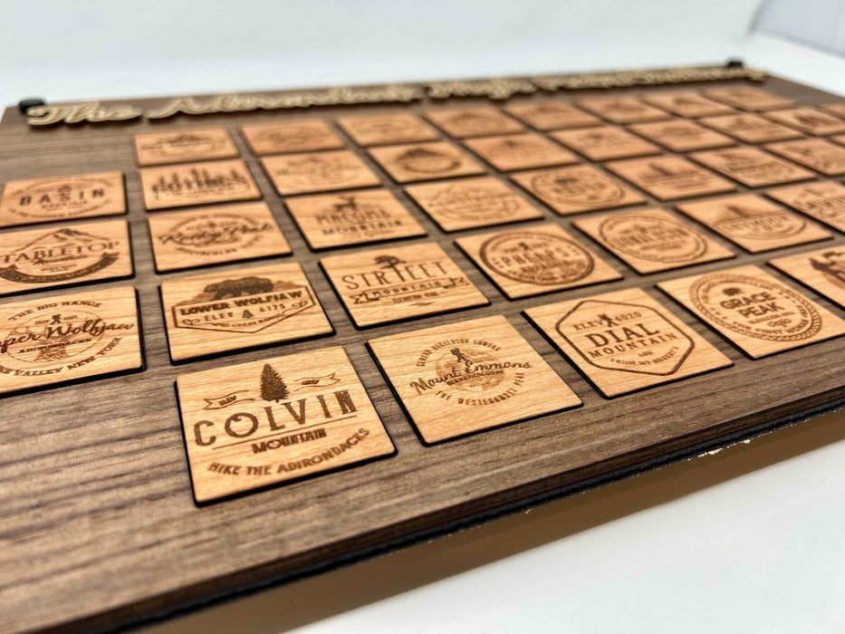 All 46 Adirondack High Peaks cherry tokens laid out — one unique token per peak