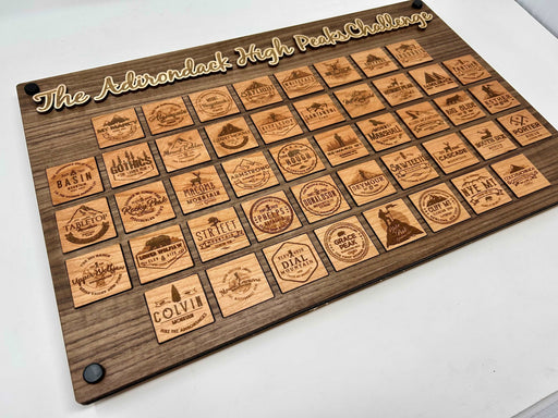 Close-up of cherry wood Adirondack High Peak token showing peak name and elevation engraving