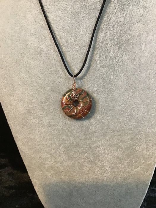 Wire wrapped gemstone donut on18" black satin adjustable cord.