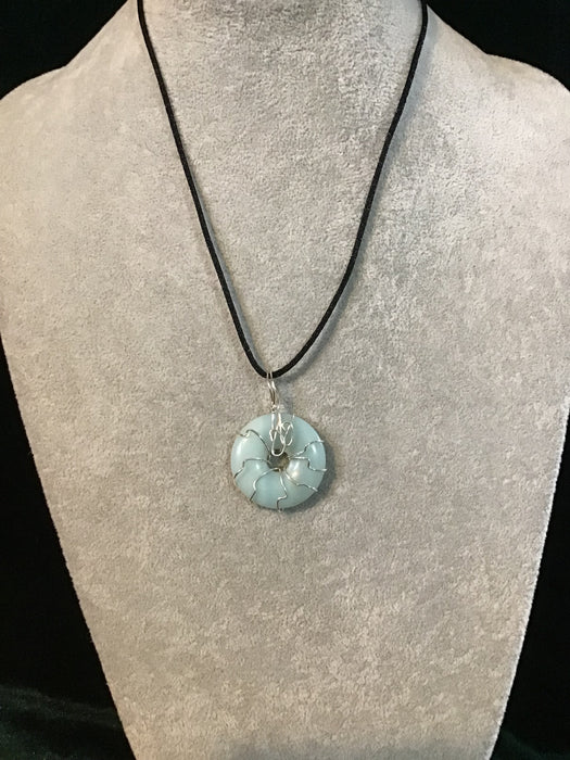 Wire wrapped gemstone donut on18" black satin adjustable cord.