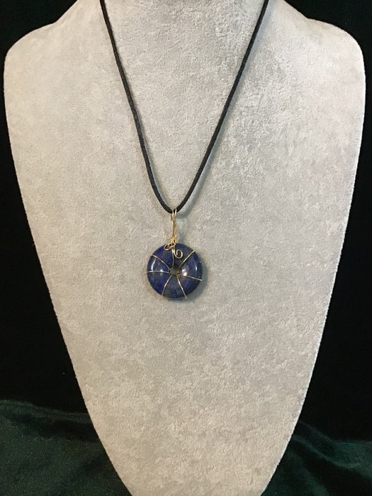 Wire wrapped gemstone donut on18" black satin adjustable cord.
