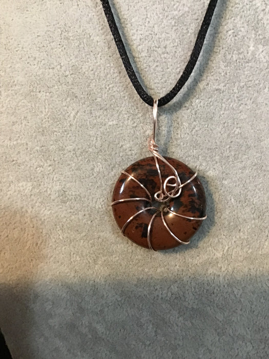 Wire wrapped gemstone donut on18" black satin adjustable cord.