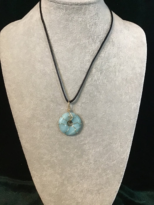 Wire wrapped gemstone donut on18" black satin adjustable cord.