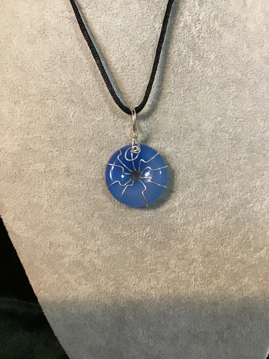 Wire wrapped gemstone donut on18" black satin adjustable cord.