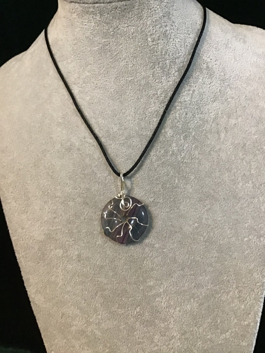 Wire wrapped gemstone donut on18" black satin adjustable cord.