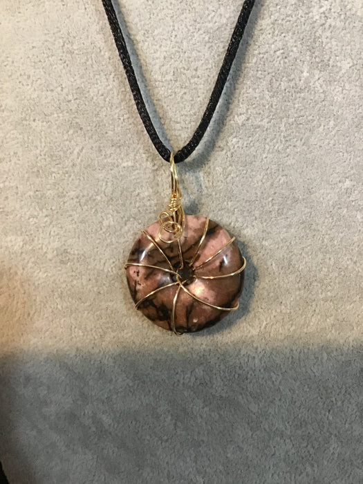 Wire wrapped gemstone donut on18" black satin adjustable cord.