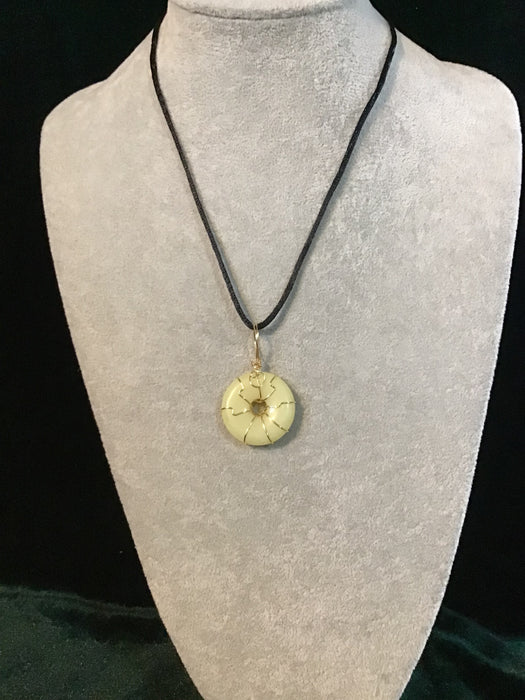Wire wrapped gemstone donut on18" black satin adjustable cord.